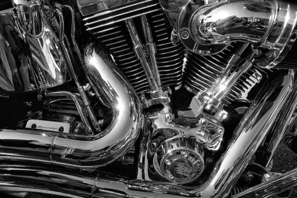Close-up of a chrome motorcycle engine with polished pipes, showing a finished chrome plating result