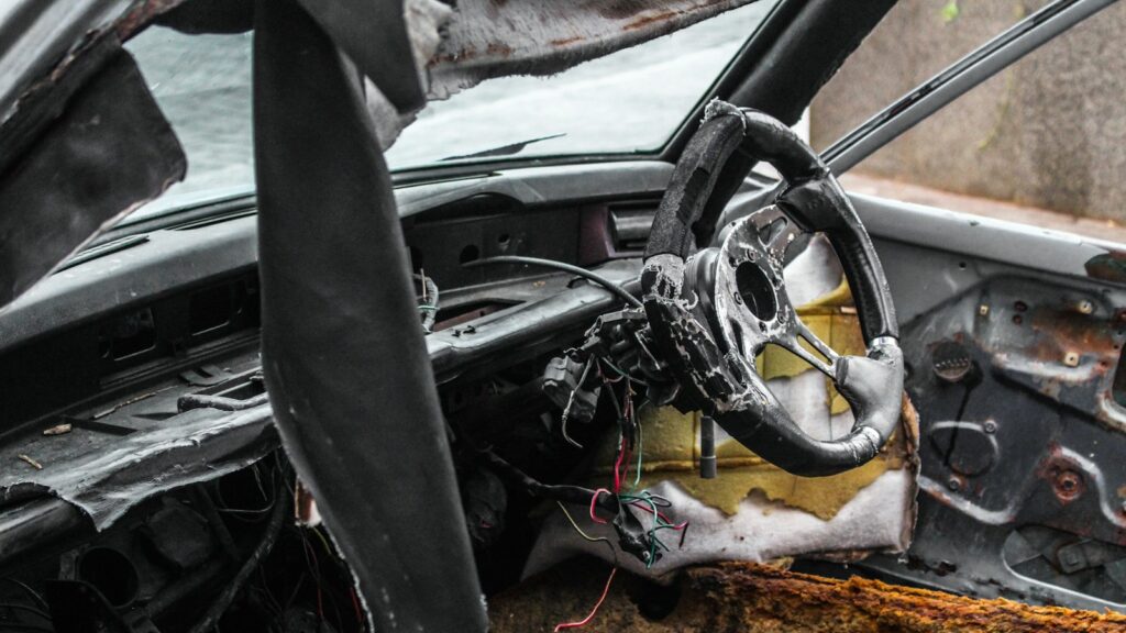 Black steering wheel in shallow focus, representing steering parts that must match a particular car